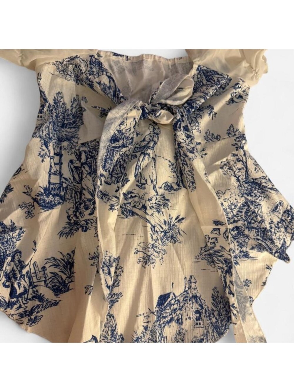 blue and white toile print blouse with tie back detail. Size M